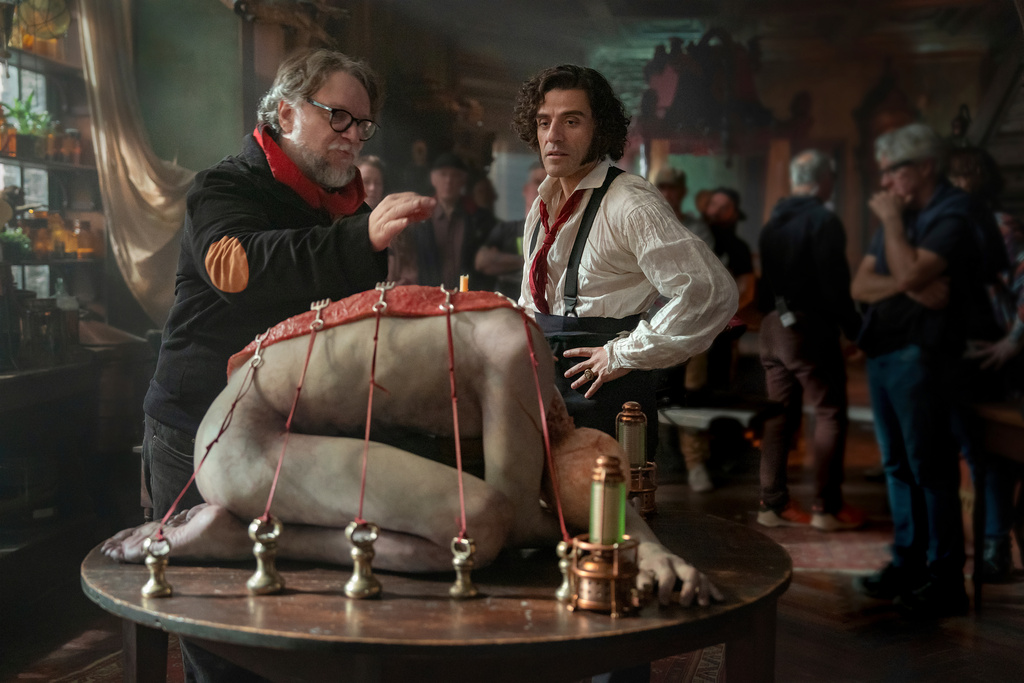 This image released by Netflix shows director Guillermo del Toro, left, and Oscar Isaac on the set of "Frankenstein." (Ken Woroner/Netflix via AP)