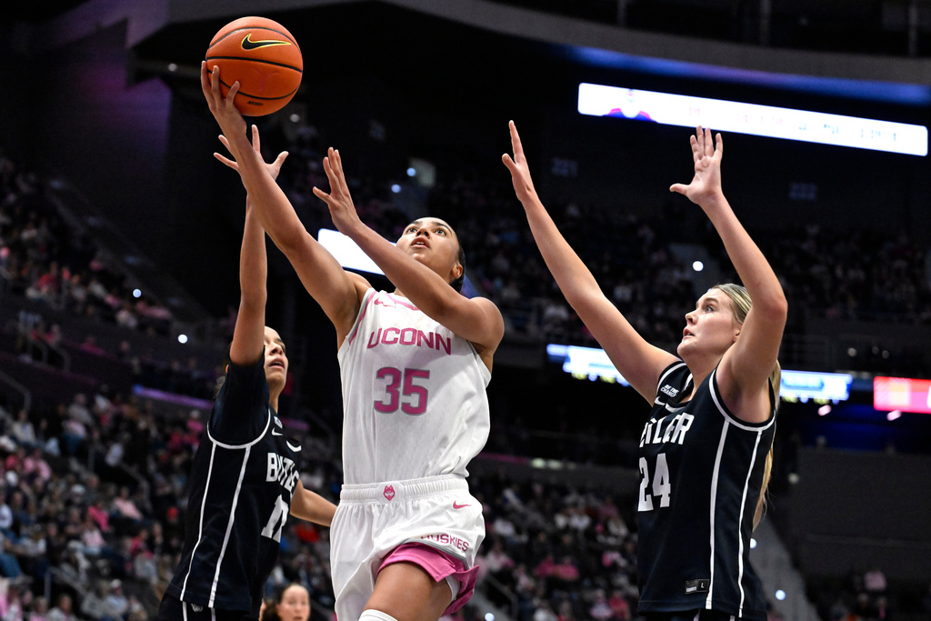 UConn guard Azzi Fudd (35) goes up for a basket between Butler guard Nevaeh Jackson, left, and forward Mallory Miller (24) in the first half of an NCAA college basketball game, Saturday, Feb. 7, 2026, in Hartford, Conn. (AP Photo/Jessica Hill)