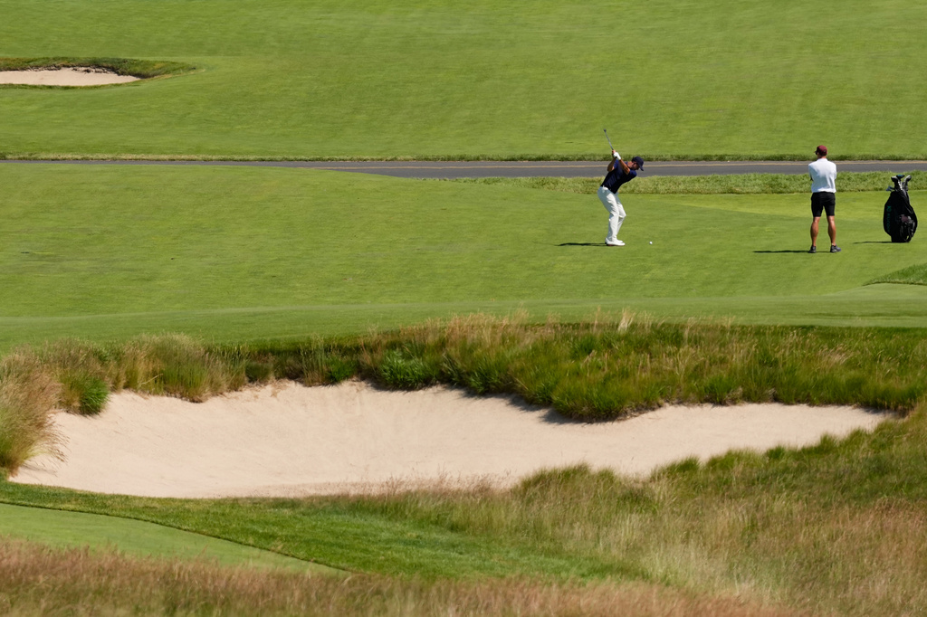 Adam Scott, of Australia, hits from the fairway on the 12th hole during a practice round for the U.S. Open golf tournament at Shinnecock Hills Golf Club in Southampton, N.Y., Wednesday, June 17, 2026.(AP Photo/David J. Phillip)