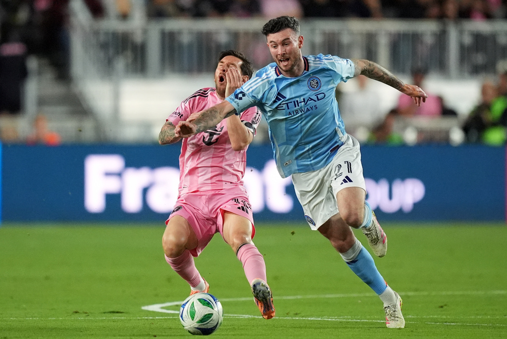 Inter Miami forward Lionel Messi, left, goes down in a clash with New York City FC midfielder Aiden O'Neill (21) during the first half of an MLS Eastern Conference final soccer match, Saturday, Nov. 29, 2025, in Fort Lauderdale, Fla. (AP Photo/Rebecca Blackwell)