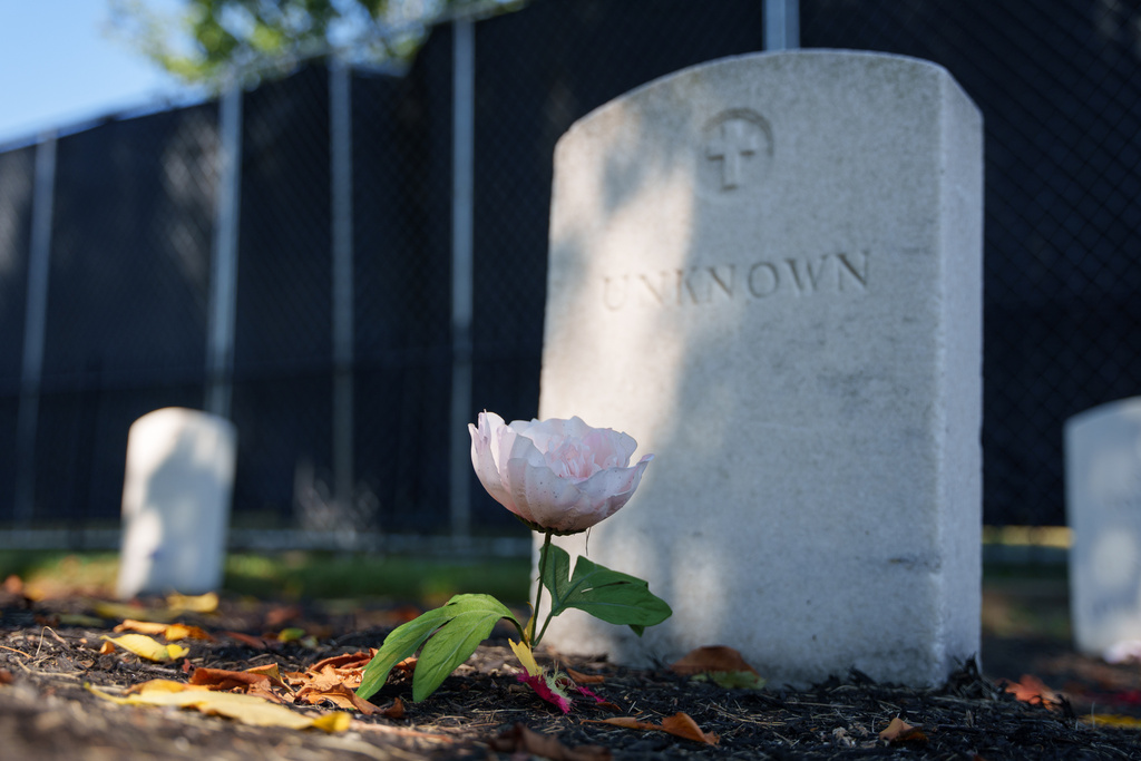 A flower rests in front of a headstone marked as "Unknown" at the Carlisle Barracks Post Cemetery in Carlisle, Pa., on Thursday, Sept. 4, 2025. (AP Photo/Mingson Lau)