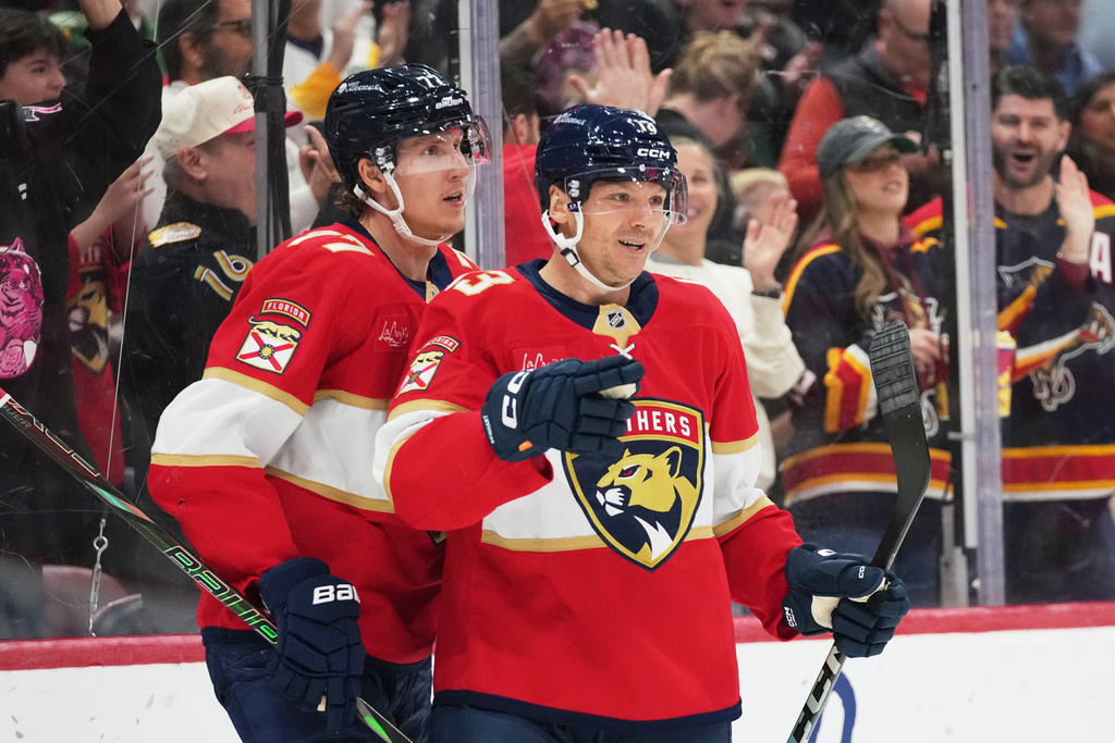 Florida Panthers center Sam Reinhart, right, reacts after scoring a goal during the second period of an NHL hockey game against the Dallas Stars, Saturday, Nov. 1, 2025, in Sunrise, Fla. (AP Photo/Lynne Sladky)