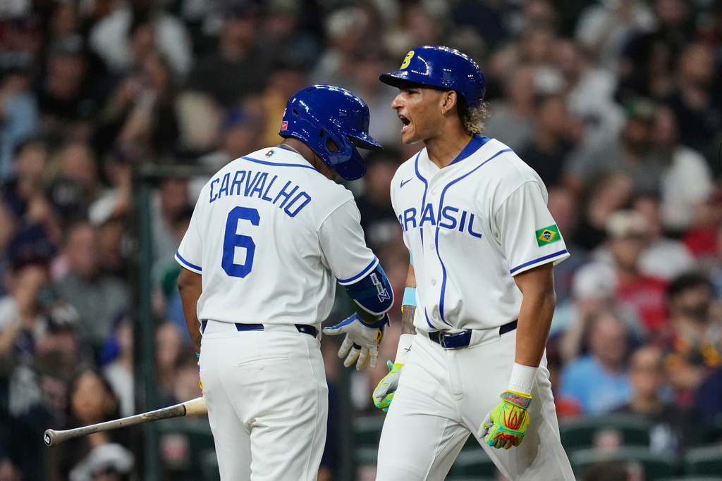 Brazil's Lucas Ramirez, right, celebrates with Osvaldo Carvalho after hitting a solo home run during the first inning of a World Baseball Classic game against the United States, Friday, March 6, 2026, in Houston. (AP Photo/Ashley Landis)