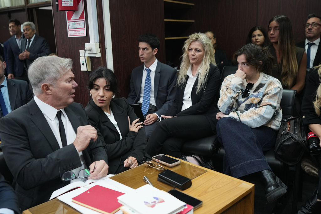 Dalma Maradona, right, and Gianinna Maradona, second left, daughters of late soccer star Diego Maradona attend the first day of the trial over allegations of homicide by negligence against the medical team that treated their father in San Isidro, Argentina, Tuesday, April 14, 2026. (AP Photo/Rodrigo Abd)