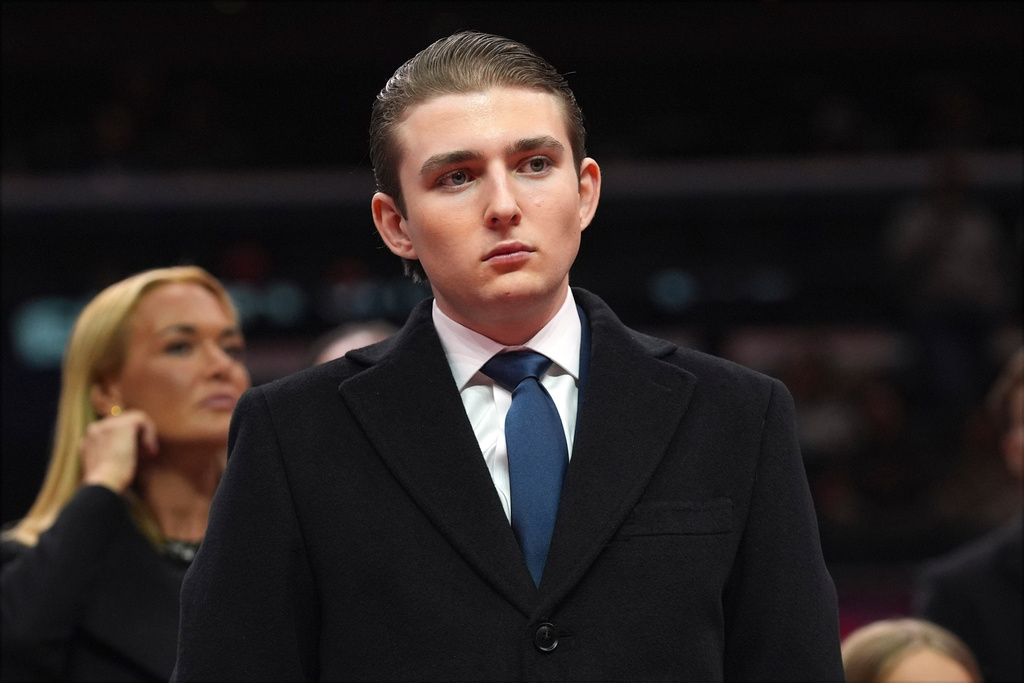FILE - Barron Trump watches as his father, President Donald Trump attends an indoor Presidential Inauguration parade event at Capital One Arena, in Washington, Jan. 20, 2025. (AP Photo/Evan Vucci, File)