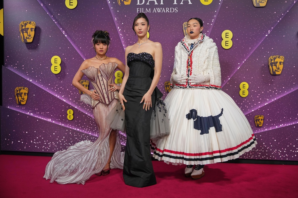 Ejae, from left Audrey Nuna and Rei Ami pose for photographers upon arrival at the 79th British Academy Film Awards, BAFTA's, in London, Sunday, Feb. 22, 2026. (AP Photo/Alastair Grant)