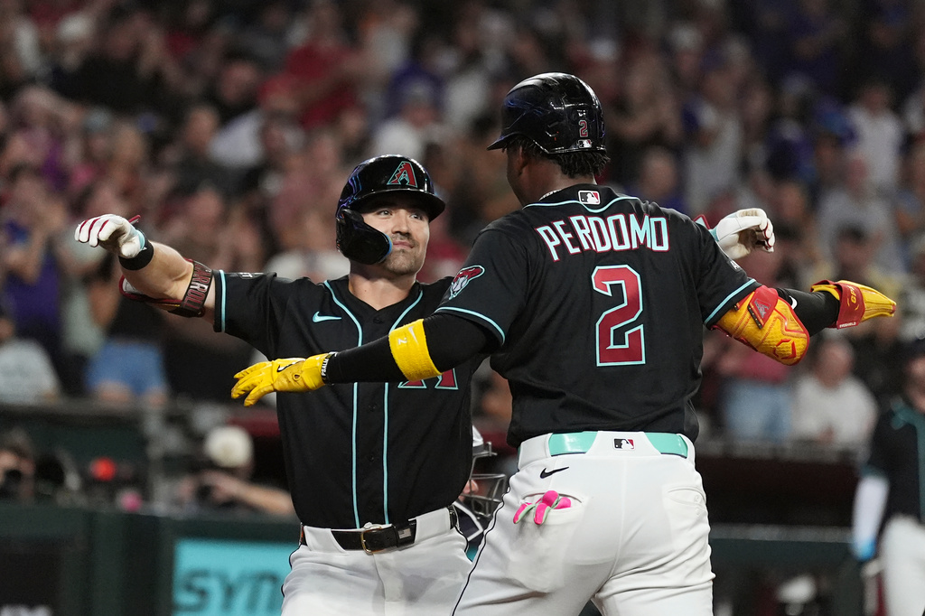 Arizona Diamondbacks' Corbin Carroll, left, celebrates his two-run home run against the New York Yankees with Diamondbacks' Geraldo Perdomo (2) during the second inning of a baseball game, Friday, Sept. 18, 2026, in Phoenix. (AP Photo/Ross D. Franklin)