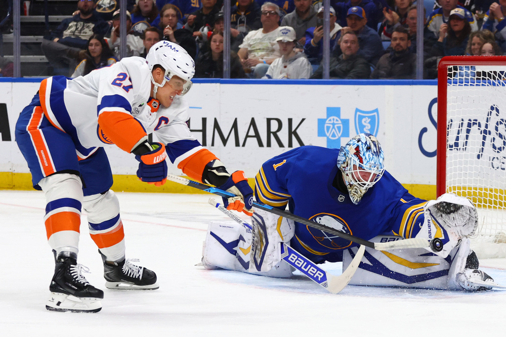 Buffalo Sabres goaltender Ukko-Pekka Luukkonen (1) stops New York Islanders left wing Anders Lee (27) on a penalty shot during the second period of an NHL hockey game Tuesday, March 31, 2026, in Buffalo, N.Y. (AP Photo/Jeffrey T. Barnes)