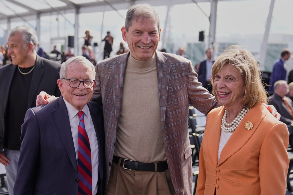Ohio Gov. Mike DeWine, left, and his wife, Frances Struewing, right, pose for a photo with former Cleveland Browns quarterback Bernie Kosar, center, before groundbreaking ceremonies for the new Browns stadium in Brook Park, Ohio, Thursday, April 30, 2026. (AP Photo/Sue Ogrocki)