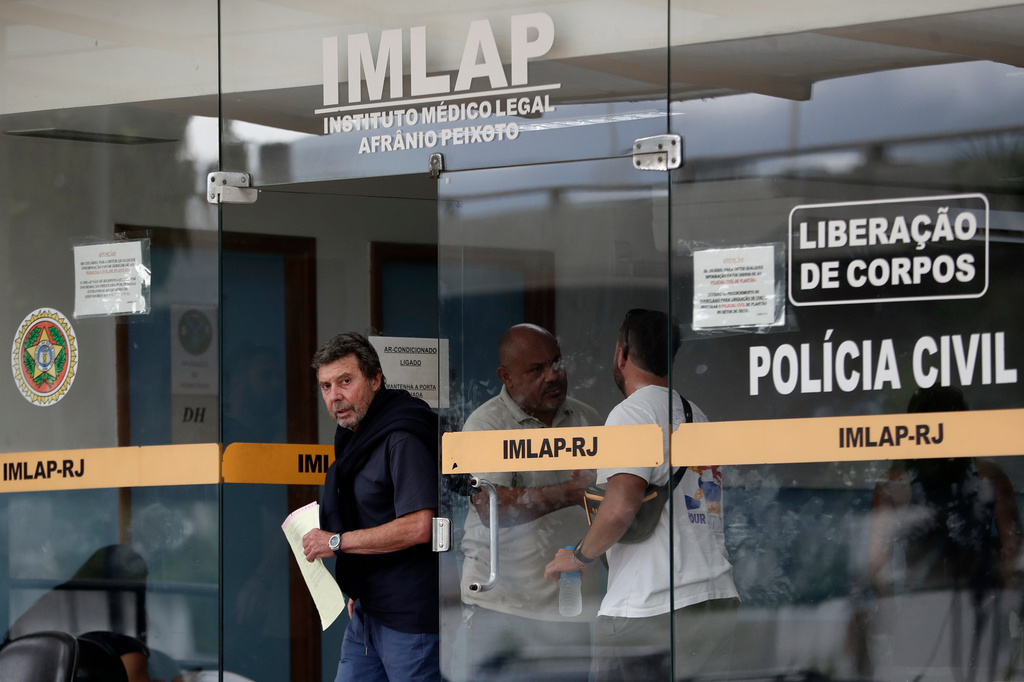 Oscar Vignale, the father of Argentine filmmaker Lucas Vignale, leaves the Medical Examiner's Office to identify and claim the body of his son who died alongside others when two helicopters collided in midair and crashed in Rio de Janeiro, Brazil, Monday, June 15, 2026. (AP Photo/Bruna Prado)