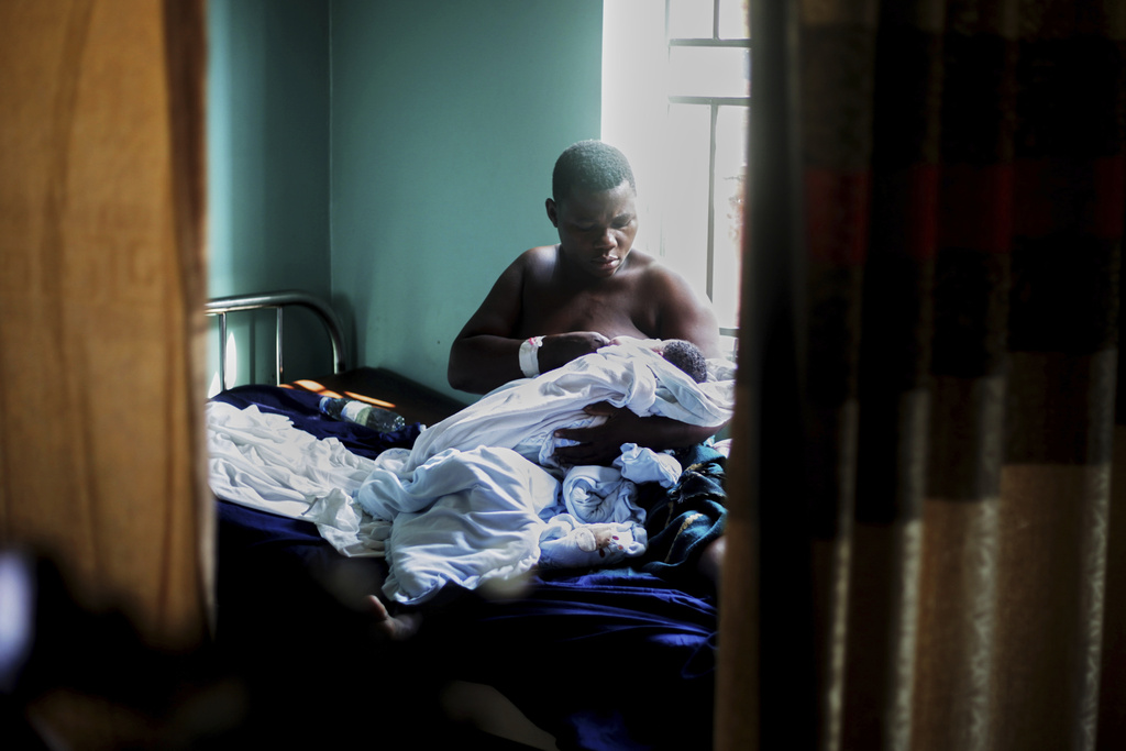 A woman breastfeeds her newborn at Wakiso Health Centre IV in Wakiso, Uganda, Tuesday, July 22, 2025. (AP Photo/Patrick Onen)