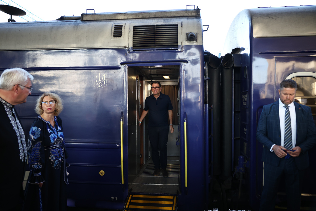 Britain's Prime Minister Andy Burnham, centre, walks out of a train upon his arrival , in Kyiv, Monday, Aug. 24, 2026. (Henry Nicholls/Pool Photo via AP)