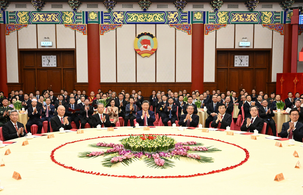 In this photo released by Xinhua News Agency, Chinese President Xi Jinping, center leads other leaders to attend the New Year gathering held by the National Committee of the Chinese People's Political Consultative Conference (CPPCC) in Beijing on Wednesday, Dec. 31, 2025. (Xie Huanchi/Xinhua via AP)