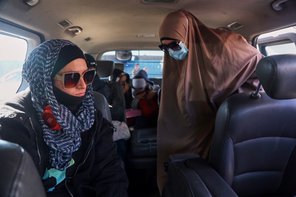 Family members of suspected Islamic State militants who are Australian nationals board a van heading to the airport in Damascus during the first repatriation operation of the year, at Roj Camp in eastern Syria, Monday, Feb. 16, 2026. Thirty-four Australian citizens from 11 families departed the camp. (AP Photo/Baderkhan Ahmad)