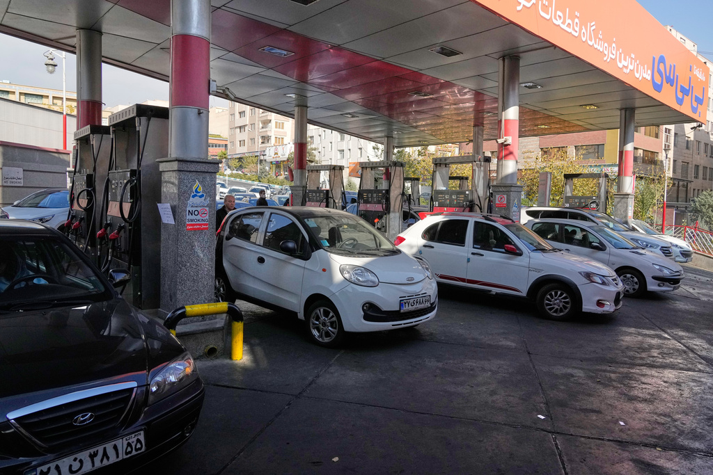 People fill their cars at a gas station in Tehran, Iran, Thursday, Nov. 27, 2025. (AP Photo/Vahid Salemi)