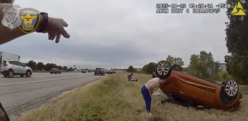 This image taken from video released by the Fort Worth Police Department shows officers responding to an overturned car before pulling a baby out from underneath Thursday, Oct. 23, 2025, in Fort Worth, Texas. (Fort Worth Police Department via AP) This image taken from video released by the Fort Worth Police Department shows officers responding to an overturned car before pulling a baby out from underneath Thursday, Oct. 23, 2025, in Fort Worth, Texas. (Fort Worth Police Department via AP)