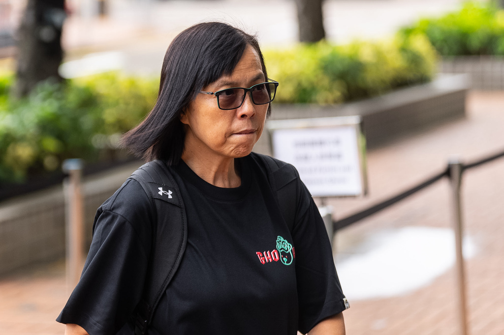Betty Ho, resident of Wang Fuk Court, arrives for the independent committee hearing for the last year's Tai Po deadly fire in Hong Kong, Wednesday, July 15, 2026. (AP Photo/Chan Long Hei)