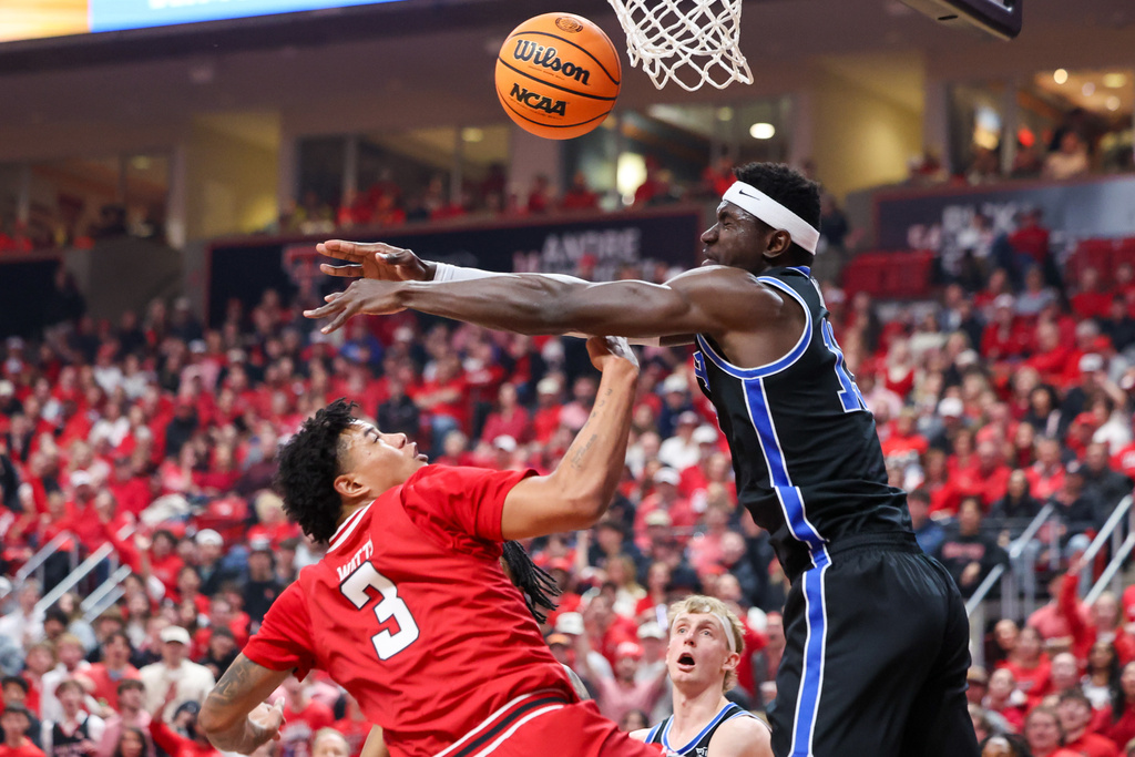 BYU center Keba Keita (13) blocks a dunk-attempt by Texas Tech forward Lejuan Watts (3) during the first half of an NCAA college basketball game Saturday, Jan. 17, 2026, in Lubbock, Texas. (AP Photo/Chase Seabolt)