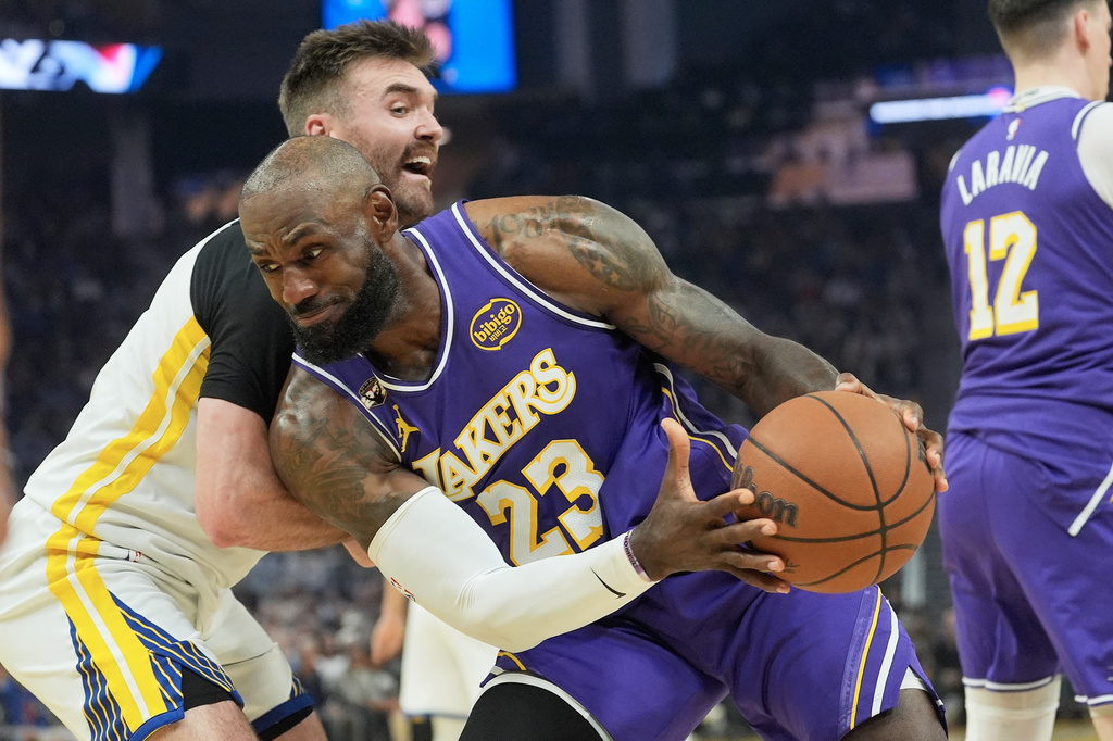 Los Angeles Lakers forward LeBron James (23) drives to the basket against Golden State Warriors guard Pat Spencer during the first half of an NBA basketball game in San Francisco, Thursday, April 9, 2026. (AP Photo/Jeff Chiu)
