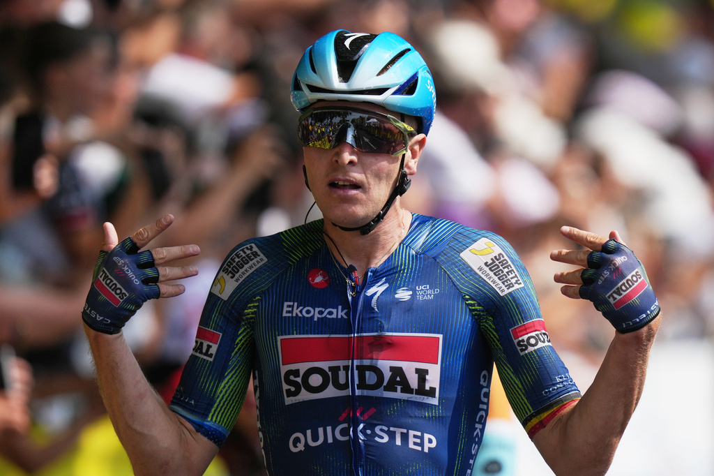 Belgium's Tim Merlier celebrates as he crosses the finish line to win the seventh stage of the Tour de France cycling race with start in Hagetmau and finish in Bordeaux, France, Friday, July 10, 2026. (AP Photo/Thibault Camus)