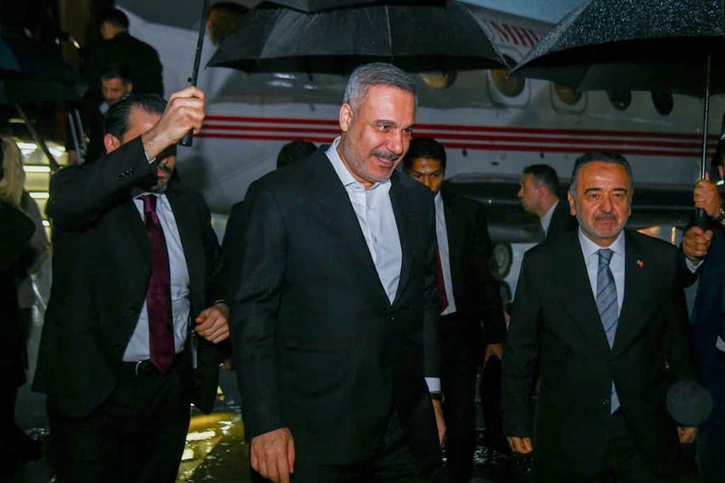 In this photo released by the Pakistan Ministry of Foreign Affairs, Turkish Foreign Minister Hakan Fidan, center, walks toward his car upon arrival to attend a meeting in Islamabad, Pakistan, Saturday, March 28, 2026. (Pakistan Ministry of Foreign Affairs via AP)