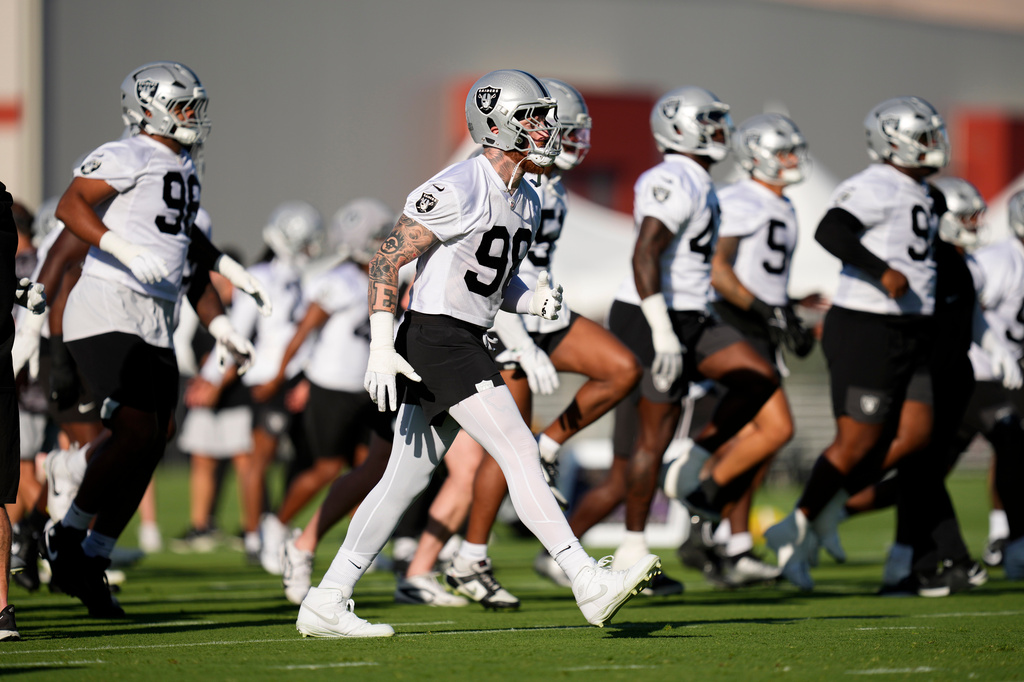 Las Vegas Raiders defensive end Maxx Crosby (98) warms up during practice at the team's NFL football training camp, Wednesday, July 29, 2026, in Henderson, Nev. (AP Photo/Lucas Peltier)