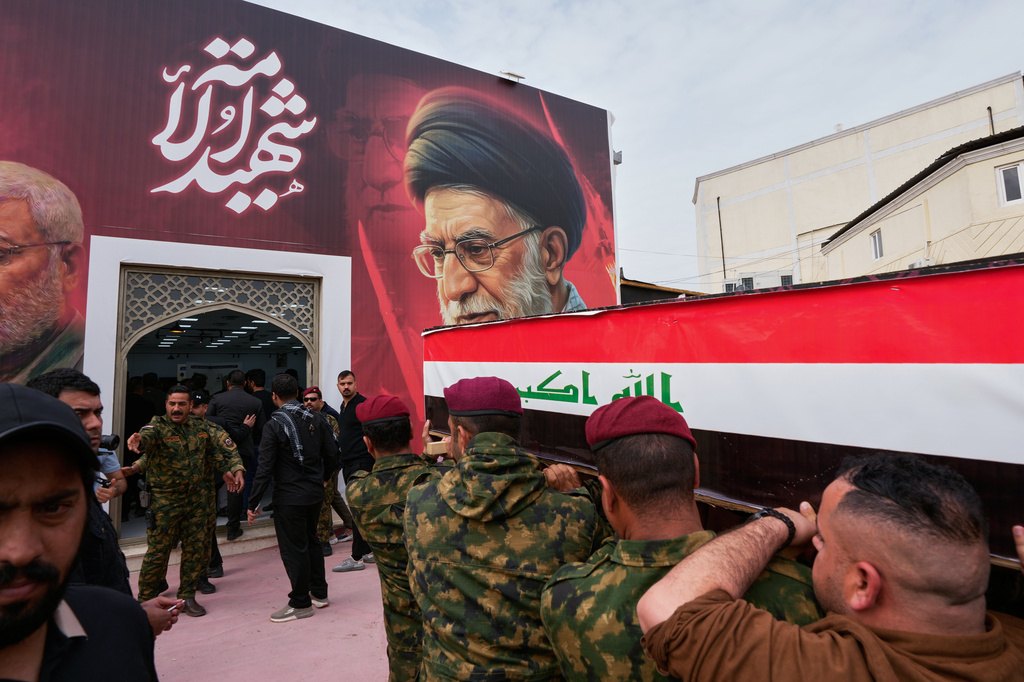 Members from the Popular Mobilization Forces attend a funeral of fighters who were killed in a U.S. airstrike, in Tal Afar, Nineveh province, north of Baghdad, Iraq, Thursday, April 2, 2026. (AP Photo/Hadi Mizban)