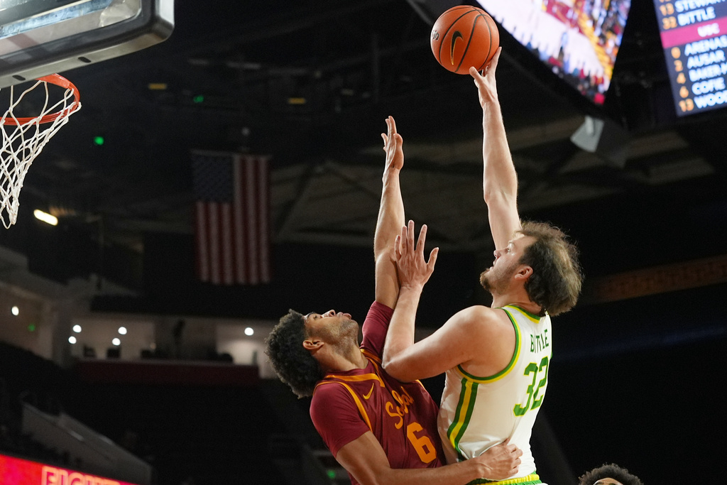 Oregon center Nate Bittle (32) shoots over Southern California forward Jacob Cofie (6) sends against during the first half of an NCAA college basketball game Saturday, Feb. 21, 2026, in Los Angeles. (AP Photo/Damian Dovarganes)