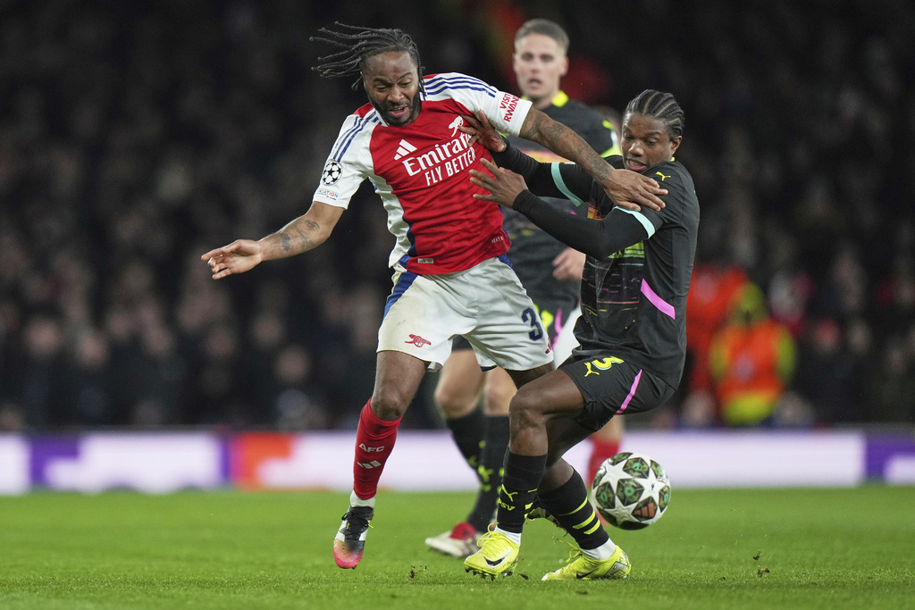FILE - PSV's Tyrell Malacia, right, challenges for the ball with Arsenal's Raheem Sterling during the Champions League round of 16 second leg soccer match between Arsenal FC and PSV Eindhoven at the Arsenal stadium in London, England, Wednesday, March 12, 2025. (AP Photo/Alastair Grant, File)