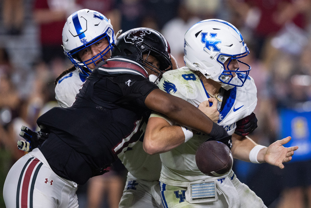 South Carolina linebacker Jatius Geer (12) knocks the ball away from Kentucky quarterback Cutter Boley (8) during the second half of an NCAA college football game, Saturday, Sept. 27, 2025, in Columbia, S.C. (AP Photo/Scott Kinser)