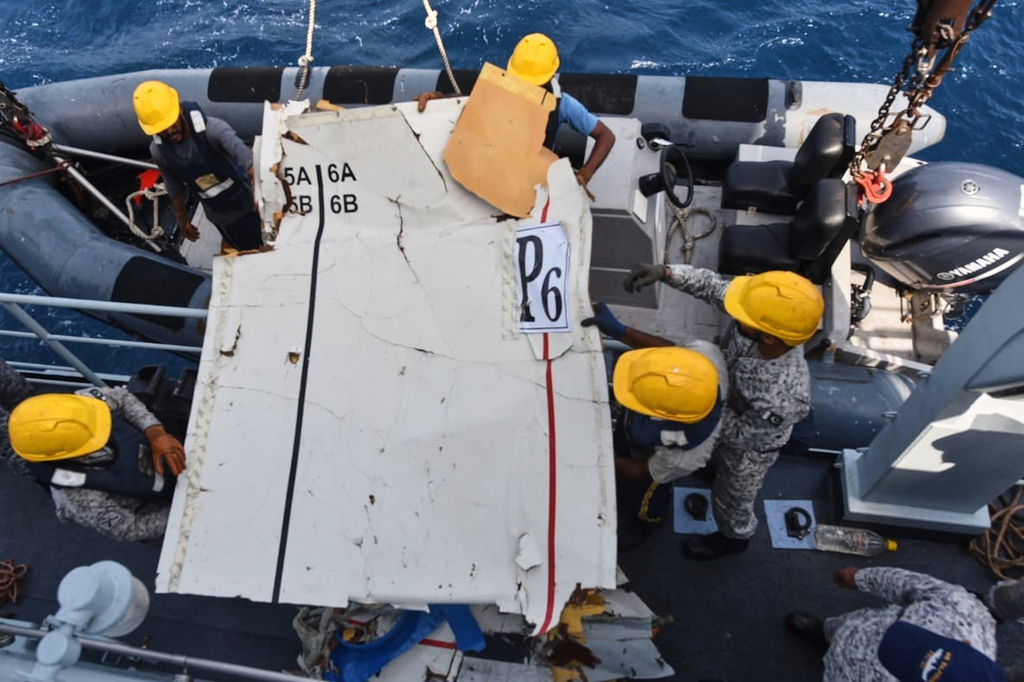 In this photo released by Pakistan Navy, Pakistan Navy personnel shift the wreckage of a cargo plane of the private carrier K2 Airways into a naval ship after recovering them from deep sea near Omara, a town some 360 kms. (220 miles) west of Karachi, Pakistan, Wednesday, July 8, 2026. (Pakistan Navy via AP)