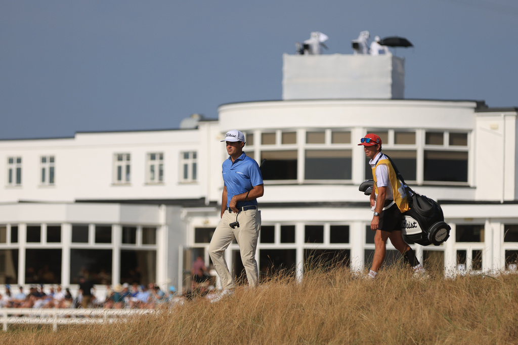 Jackson Suber of the United States, and his caddie Greyson Porter walks towards the 18th green during the first day of the British Open Golf championships at Royal Birkdale golf club, in Southport, England, Thursday, July 16, 2026. (AP Photo/Peter Morrison)