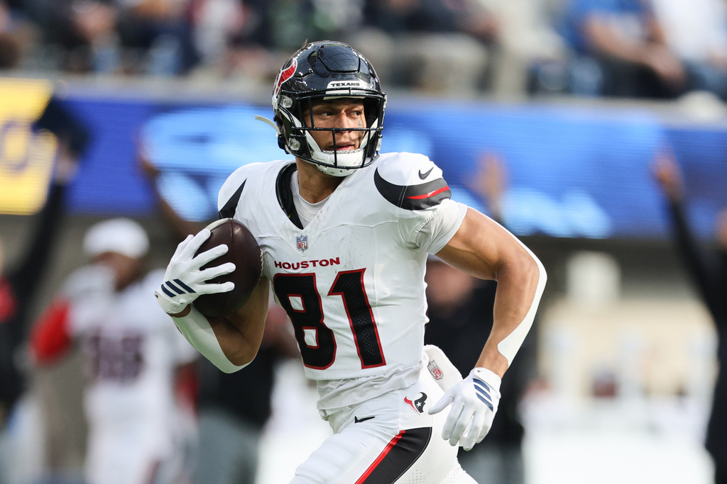 Houston Texans wide receiver Jayden Higgins (81) runs to score a touchdown during the first half of an NFL football game against the Los Angeles Chargers Saturday, Dec. 27, 2025, in Inglewood, Calif. (AP Photo/Kevork Djansezian)