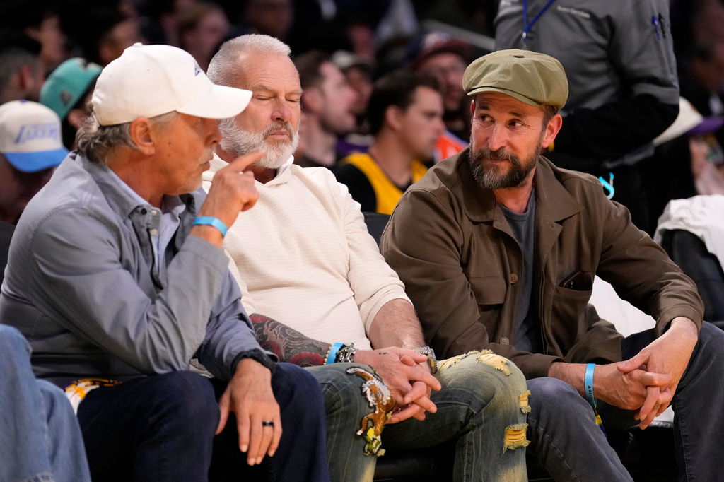 Actor Noah Wyle, right, talks with actor Don Johnson, during the first half of Game 3 in a second-round NBA basketball playoffs series between the Los Angeles Lakers and the Oklahoma City Thunder, Saturday, May 9, 2026, in Los Angeles. (AP Photo/Mark J. Terrill)