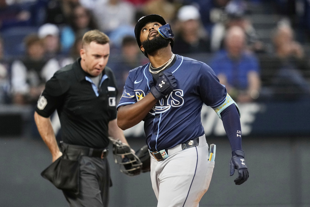 Tampa Bay Rays' Junior Caminero gestures as he crosses home plate with a home run in the fifth inning of a baseball game against the Cleveland Guardians in Cleveland, Monday, Aug. 25, 2025. (AP Photo/Sue Ogrocki)