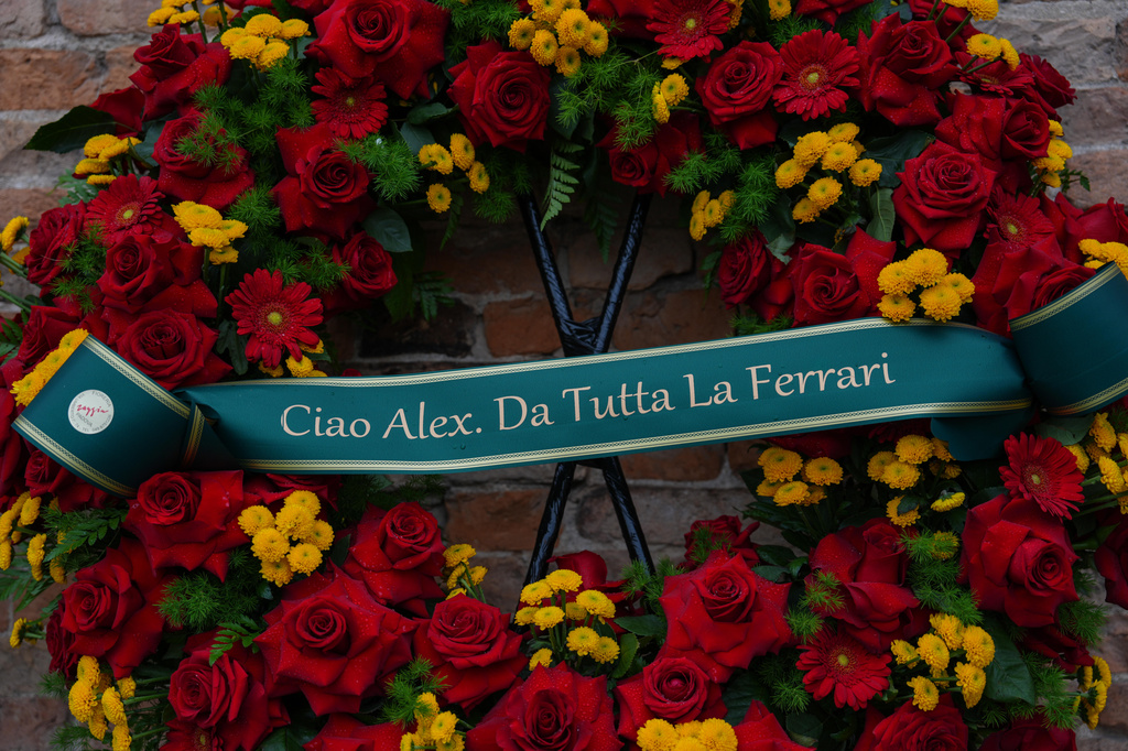 A wreath reading " Hello Alex, from all at the Ferrari ", during the funeral of Alex Zanardi, Italian auto racing champion-turned-Paralympic gold medalist, inside the Basilica of Santa Giustina, Padua, Italy, Tuesday, May 5, 2026. (Claudio Furlan/LaPresse via AP)