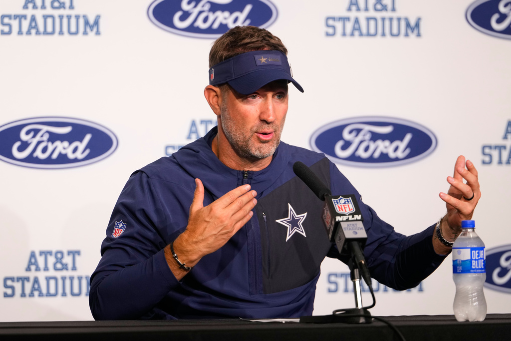 Dallas Cowboys head coach Brian Schottenheimer responds to questions during a news conference after an NFL football game against the Green Bay Packers Sunday, Sept. 28, 2025, in Arlington, Texas. (AP Photo/Jeffrey McWhorter)