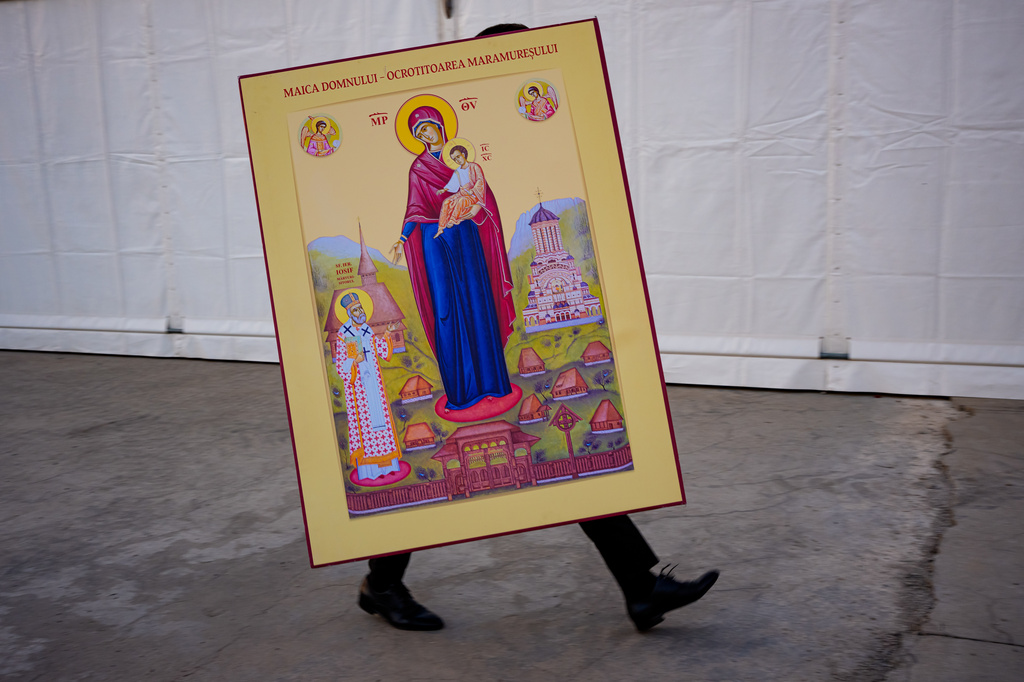 A man carries a religious icon before the Procession of Lights, part of a four-day program of the International Meeting of Orthodox Youth (ITO), in Bucharest, Romania, Wednesday, Sept. 2, 2026. (AP Photo/Andreea Alexandru)