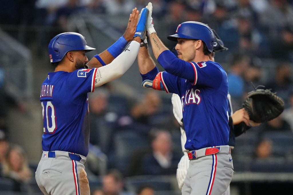 Texas Rangers' Evan Carter, right, celebrates with Ezequiel Duran after they scored on a two-run home run by Carter during the third inning of a baseball game against the New York Yankees, Wednesday, May 6, 2026, in New York. (AP Photo/Frank Franklin II)