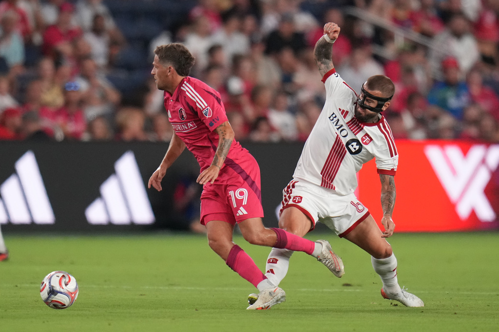 Toronto FC's Niklas Dorsch, right, challenges St. Louis City's Carlo Holse (19) for the ball during the first half of an MLS soccer match Saturday, Sept. 19, 2026, in St. Louis. (AP Photo/Jeff Roberson)