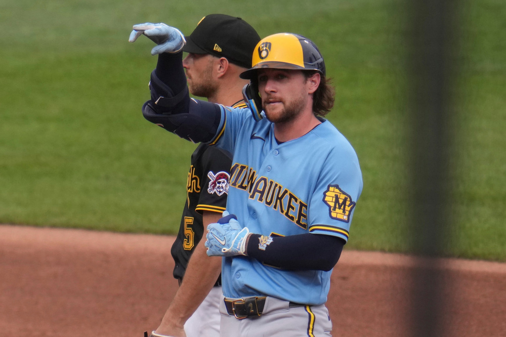 Milwaukee Brewers' Brice Turang, front, celebrates on second base after driving in two runs with a double off Pittsburgh Pirates pitcher Bubba Chandler during the fifth inning of the second game of a baseball doubleheader in Pittsburgh, Saturday, July 11, 2026. (AP Photo/Gene J. Puskar)