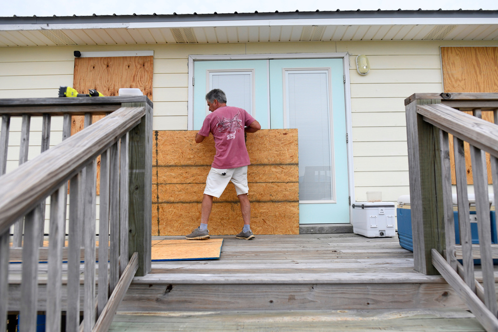 Larry Smith boards up his home with plywood ahead of Hurricane Isaias' expected landfall along the Gulf Coast in Dauphin Island, Alabama, Thursday, Oct. 8, 2026. (AP Photo/Octavio Jones)