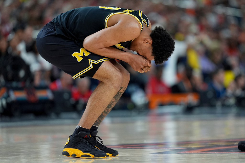 Michigan forward Yaxel Lendeborg reacts after an injury on the court during the first half of an NCAA college basketball tournament semifinal game against Arizona at the Final Four, Saturday, April 4, 2026, in Indianapolis. (AP Photo/Abbie Parr)