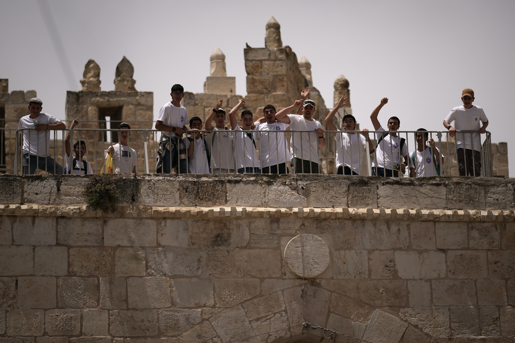 Israelis shout slogans as they gather in the Old City to participate in a march marking Jerusalem Day, an Israeli holiday celebrating the capture of east Jerusalem in the 1967 Mideast war, in Jerusalem, Thursday, May 14, 2026. (AP Photo/Leo Correa)