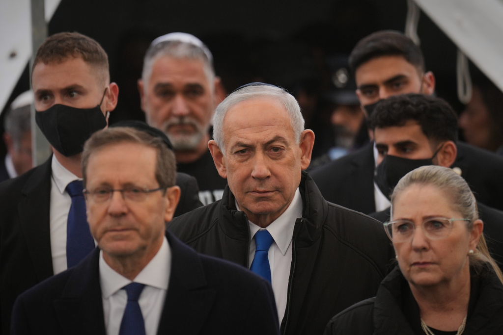 Israeli prime minister Benjamin Netanyahu and President Isaac Herzog arrive for the funeral of Ran Gvili, the last Israeli hostage whose remains were recovered from the Gaza Strip, in Meitar, Israel, Wednesday, Jan. 28, 2026. (AP Photo/Ariel Schalit)