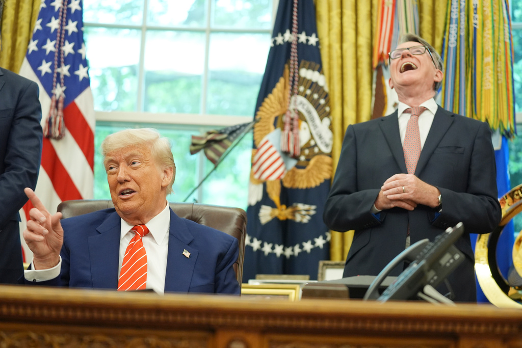 FILE - President Donald Trump, left, gets a reaction from Britian's ambassador to the United States Peter Mandelson, right, as they take questions from members of the media after announcing a trade deal between U.S. and U.K. in the Oval Office of the White House, Thursday, May 8, 2025, in Washington. (AP Photo/Evan Vucci, file)