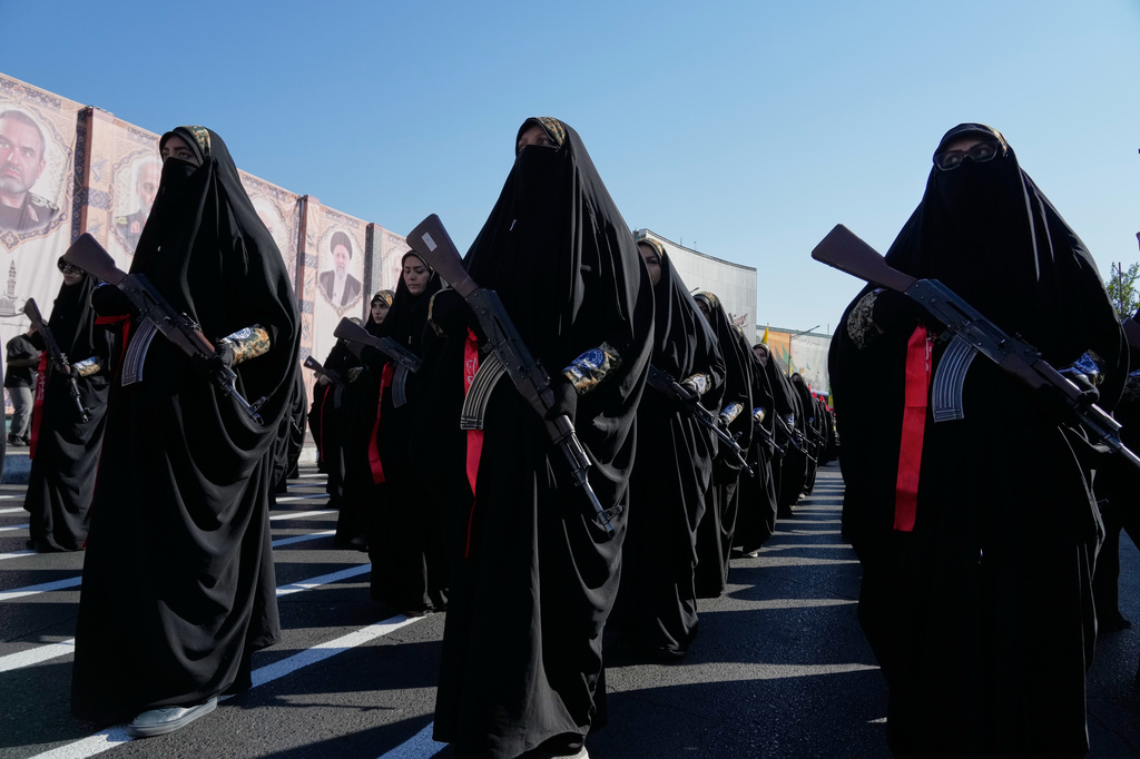 Women affiliated with Iran's Revolutionary Guard carry rifles as they march during the state-organized "Janfada," or "Sacrifice for Iran," military exercise in Tehran, Iran, Friday, Sept. 18, 2026. (AP Photo/Vahid Salemi)
