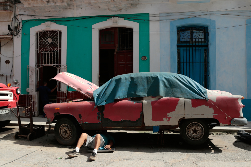 A man works on a classic American car in Havana, Cuba, Wednesday, June 17, 2026. (AP Photo/Jorge Luis Banos)