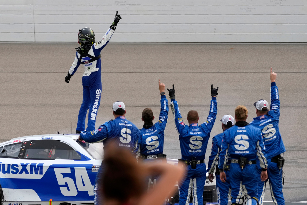 Ty Gibbs, top, celebrates with crew members after winning a NASCAR Cup Series auto race, Sunday, Aug. 9, 2026, at Iowa Speedway in Newton, Iowa. (AP Photo/Charlie Neibergall)