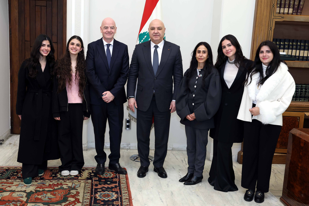 In this photo released by the Lebanese Presidency press office, Lebanese President Joseph Aoun, centre right, stands next to FIFA President Gianni Infantino, centre left, with members of his family, at the presidential palace in Baabda east of Beirut, Lebanon, Monday, Feb. 16, 2026. (Lebanese Presidency press office via AP)